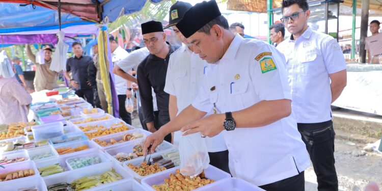 Bupati Aceh Besar H Muharram Idris memilih dan membeli menu bukaan saat peninjauan penjualan takjil di Pasar Jantho Aceh Besar Rabu 532025 sore FOTO PROKOPIM PEMKAB ACEH BESAR