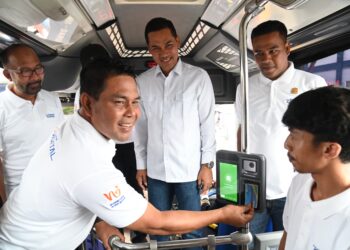 Bupati Aceh Besar, H Syech Muharram Idris menempelkan kartu Trans Koetaradja dalam acara Lahunching Pelayanan Trans Koetaradja di Komplek Terminal Tipe A Batoh, Band Aceh Aceh, Minggu (04/05/2025). FOTO/MC ACEH BESAR