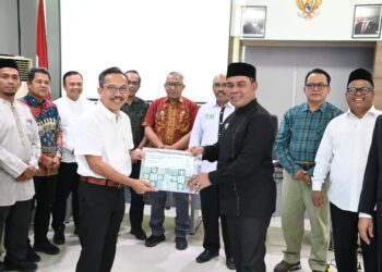 Bupati Aceh Besar, H Syech Muharram Idris menerima dokumen Potret Wilayah Adat Mukim dari Kepala Badan Registrasi Wilayah Adat, Kasmita Widodo pada acara menghadiri Kick off Meeting Riset Tenurial Subyek dan Objek Masyarakat Hukum Adat di Aula Balai Senak Lt 2 USK, Darussalam, Banda Aceh, Jumat (22/08/2025). FOTO/MC ACEH BESAR