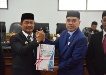 Wakil Bupati Aceh Besar Drs. H. Syukri A Jalil menyerahkan Dokumen Raqan RPJMD kepada Ketua DPRK di Gedung Paripurna Kota Jantho, Selasa (9/9/2025). FOTO/MC ACEH BESAR