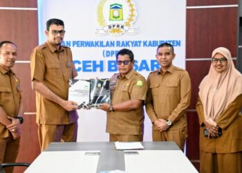 Sekda Aceh Besar Bahrul Jamil, SSos MSi menyerahkan KUA dan Rancangan PPAS kepada Sekwan DPRK Aceh Besar, Fata Muhammad SPdI MM di Ruang Rapat DPRK Aceh Besar Kota Jantho, Selasa (18/11/2025). FOTO/ MC ACEH BESAR