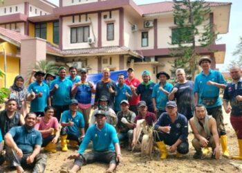 Puluhan relawan Aparatur Sipil Negara (ASN) dari Dinas Kesehatan Aceh foto bersama usai membersihkan kantor Dinas Kesehatan Kabupaten Aceh Tamiang dari genangan lumpur pada 29 hingga 30 Desember 2025.