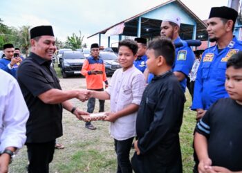 Bupati Aceh Besar, Muharram Idris menyerahkan santuan anak yatim sebelum buka puasa bersama di Posko BPBD Aceh Besar, Gampong Sibreh Keumude, Kecamatan Sukamakmur, Aceh Besar, Sabtu (28/02/2026). FOTO/MC ACEH BESAR