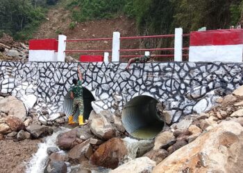 personel TNI dari Koramil 04/Pintu Rime Gayo (PRG) Kodim 0119/Bener Meriah terus mengintensifkan pekerjaan finishing guna memastikan jembatan tersebut segera rampung dan siap difungsikan, Minggu (26/04/2026). [FOTO: KODAM IM]