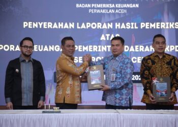 Bupati Aceh Besar H Muharram Idris didampingi Ketua DPRK Aceh Besar Abdul Muchti saat menerima dokumen LHP BPK RI Perwakilan Aceh, di Kantor BPK RI Perwakilan Aceh di Banda Aceh, pada Kamis (4/6/2026). FOTO/ MC ACEH BESAR