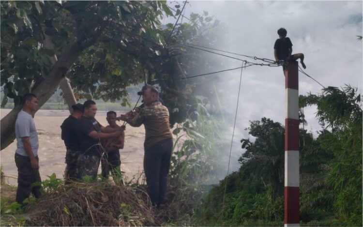 Anggota Babinsa Kodim 0108Aceh Tenggara bersama masyarakat dan tim teknis bergotong royong melaksanakan pemasangan tali sling tambahan pada sisi kiri dan kanan Jembatan Gantung Perintis di Desa Kumbang Jaya Kecamatan Badar Kabupaten Aceh Tenggara pada Sabtu 2692026