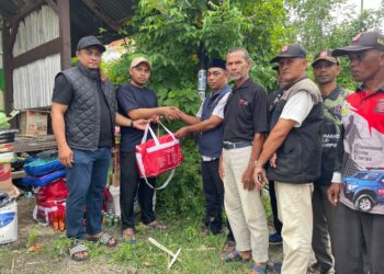 Kadis Sosial Aceh Besar Darwan Asrizal SE MT, menyerahkan bantuan masa panik kepada warga korban terdampak kebakaran rumah, di Komplek Permata Punie, Gampong Punie, Kecamatan Darul Imarah, Kabupaten Aceh Besar, Minggu (25/10/2026). FOTO/ MC ACEH BESAR
