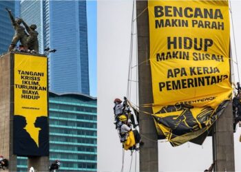 Enam aktivis Greenpeace Indonesia membentangkan spanduk di Patung Selamat Datang, Bundaran Hotel Indonesia (HI), Jakarta Pusat, Selasa (20/10/2026).